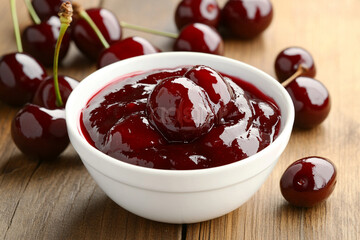Homemade cherry jam served in a bowl with fresh cherries around