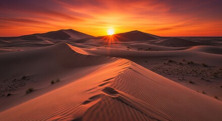 Breathtaking Desert Sunrise Illuminates Rolling Sand Dunes with Vibrant Orange Sky