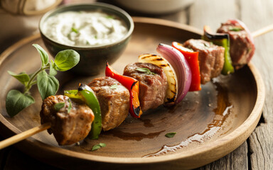 Grilled Beef Balkan Raznici with Colorful Vegetables on Rustic Wooden Serving Board
