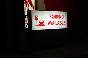 Parking Available Sign with Subtle Red Glow at Night