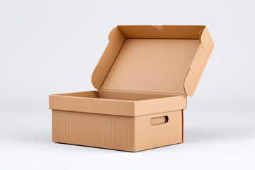 Cardboard box is open and empty. The box is brown and has a rectangular shape. The box is sitting on a white surface