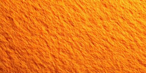 Closeup of a rich textured orange felt surface with a complex layered pattern and plush fuzzy appearance creating a cozy and warm backdrop