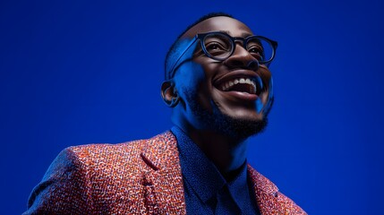 Portrait of a confident smiling motivational speaker wearing glasses and a professional suit exuding enthusiasm and
