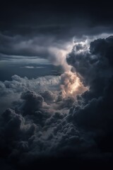 Obraz premium A dramatic view of dark storm clouds illuminated by a flash of lightning, highlighting the powerful and intense atmosphere of a turbulent sky.