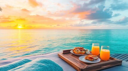 Breakfast served on a wooden tray overlooking the ocean at sunset.