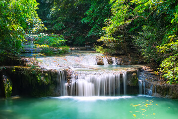 Beautiful scenery of Erawan Waterfall in dense tropical jungle in Kanchanaburi National Park, Thailand.