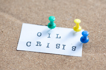 pinning the oil crisis message to a corkboard with pins