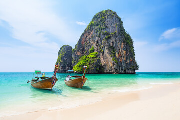 Amazing view of Ao Phra Nang Beach with thai traditional wooden longtail boat, white sand and turquoise sea in Krabi province. Ao Nang, Thailand.