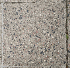 Textured concrete pavement revealing intricate patterns on a city street during daytime
