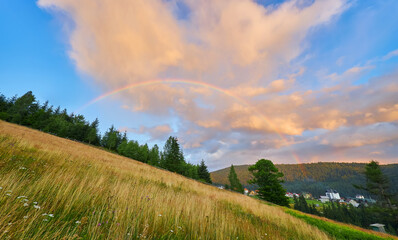 Rainbow Over Mountain Village Sunset