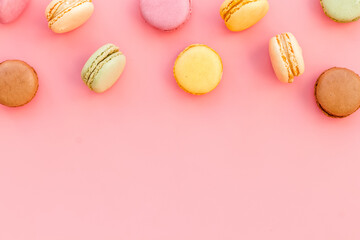 Macarons design on pink background top view space for text