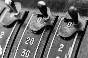 Vintage cash register buttons showcase intricate design and history in a warm-toned shop during the...
