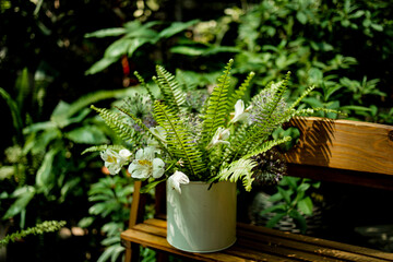 bouquet of White flowers Alstroemeria , Peruvian lilies and Nephrolepis cordifolia,Habitus, in the garden on the bench