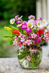 Beautiful bouquet of summer wild flowers in a green garden