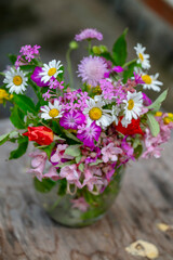 Beautiful bouquet of summer wild flowers in a green garden