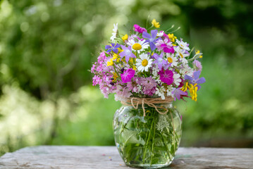 Beautiful bouquet of summer wild flowers in a green garden
