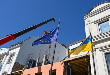 New flags raised to symbolize unity in a construction area under clear blue sky