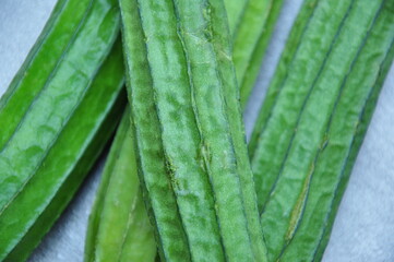 Several vibrant green ridge gourds (Luffa acutangula) 