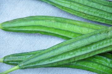 Several vibrant green ridge gourds (Luffa acutangula) 