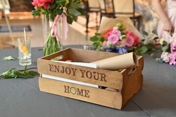A decorative box with floral arrangement supplies and the text 