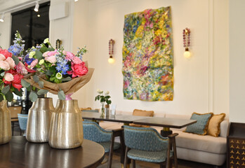 Finished flower bouquets created during the workshop are displayed in a vase.