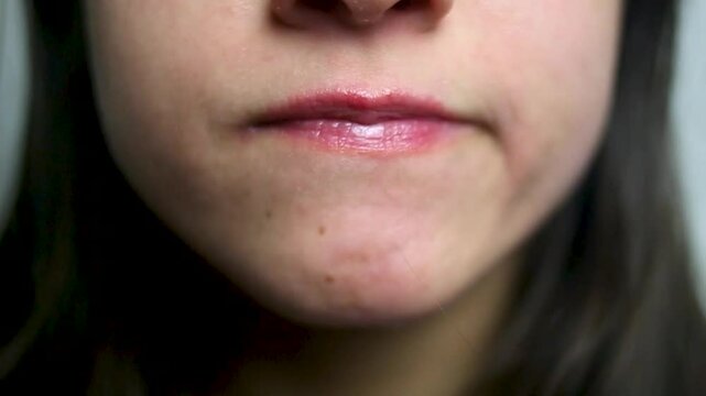 Female mouth biting the lips