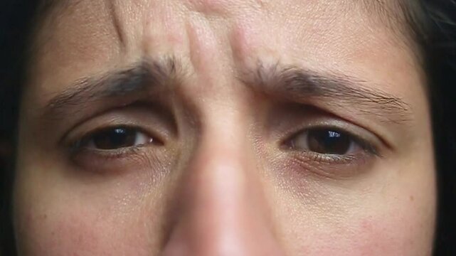 Feminine expression with furrowed brows