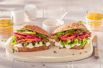 Healthy and crispy sandwich served with lemonade in the kitchen.