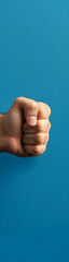 close-up view of a clenched fist slamming onto a table vertical banner - wide skyscraper - blue background