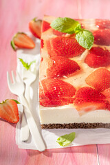 Delicious and chilly strawberry cheesecake with transparent jelly and cream.