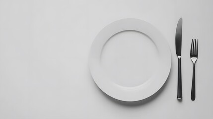 Empty White Plate with Knife and Fork Minimalist Table Setting