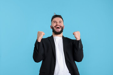 Happy Birthday. Handsome man with party hat on light blue background