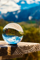 Crystal ball alpine spring landscape shot with Mount Wilder Kaiser in the background at Kaiserlift Kufstein, Tyrol, Austria