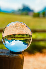 Crystal ball alpine spring landscape shot with a fortress in the background at Kufstein, Tyrol, Austria