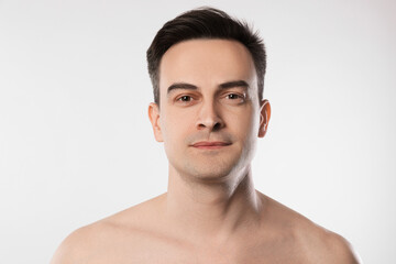 Fototapeta premium Portrait of handsome man on light grey background, closeup