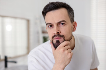 Portrait of handsome man before shaving in bathroom