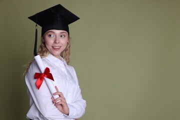 Happy student with diploma after graduation on green background. Space for text