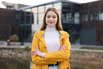 Fototapeta premium Portrait of beautiful teenage girl on city street