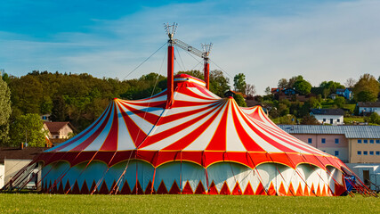 Spring landscape with a red and white circus tent on a sunny day at Postmuenster, Rottal Inn, Bavaria, Germany