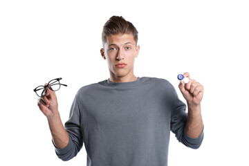 Man choosing between glasses and contact lenses on white background