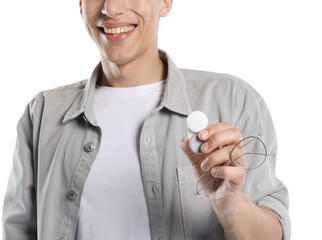 Man with glasses and contact lenses on white background, closeup