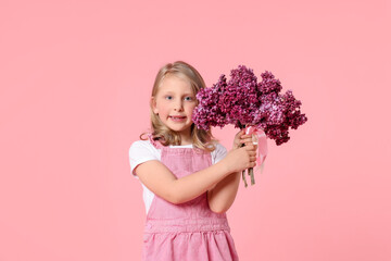 Little girl with bouquet of lilac flowers on pink background