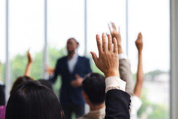 Question and answer audience or crowd : Active participation Asian man raise hands to ask questions attending seminar in conference meeting and training