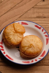 fried cassava on a white ceramic plate. Cassava is a staple food and one of the sources of...