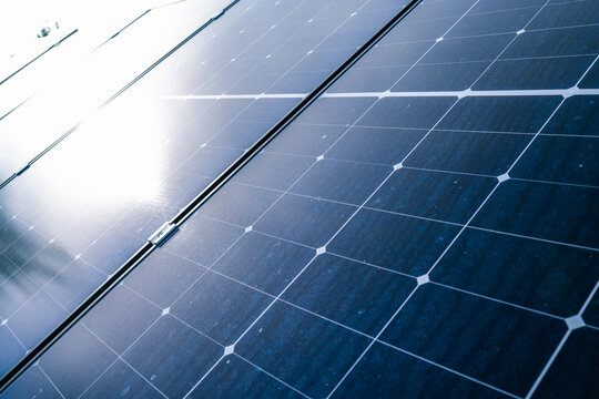 Close-up of solar panel surface reflecting soft evening sky light, highlighting clean energy technology details