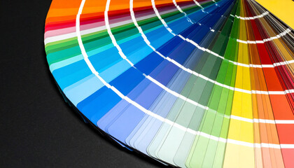 Color swatches fan out on a dark surface, showcasing a wide spectrum from blues to yellows