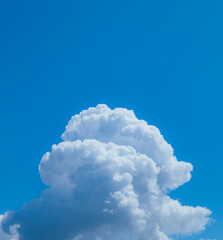 Fluffy mushroom cloud on a sunny day against a blue sky