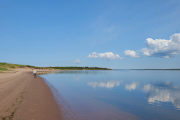 sand beach with beautiful sky with clouds in background prince edward island Canada. High quality photo