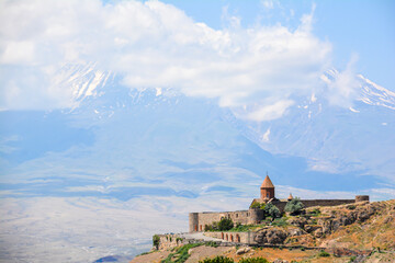 Church and beautiful natural landscape. Monastery in nature. Armenian monastery Khor Virap. Beautiful architecture of the church. Monastery against the backdrop of rocky mountains. Christianity