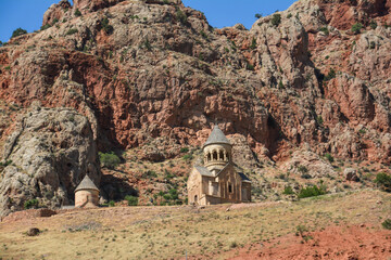 Church and beautiful natural landscape. Monastery in nature. Armenian Apostolic Church Noravank. Beautiful architecture of the church. Monastery against the backdrop of rocky mountains. Christianity i